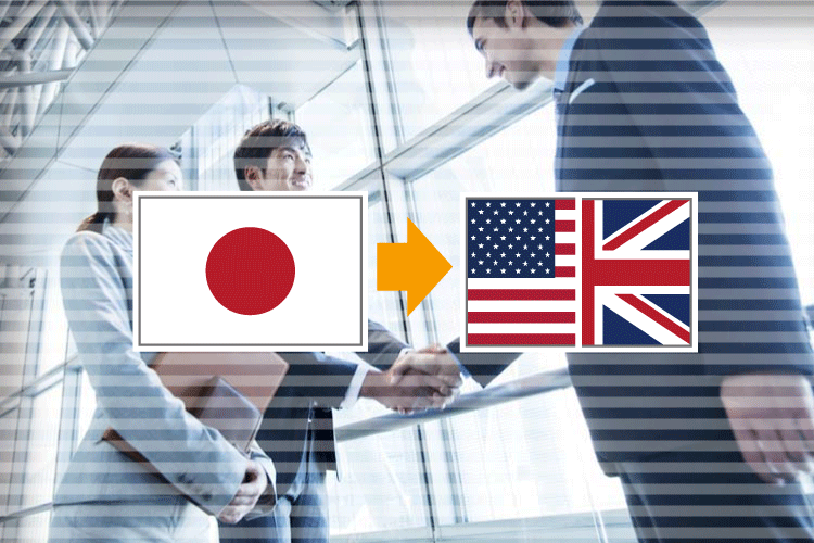 握手をするビジネスマンのイメージに日本とUS/UKの国旗