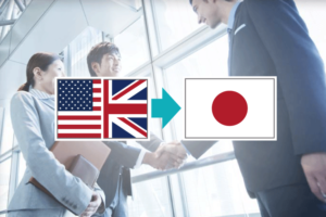 握手をするビジネスマンのイメージにUS/UKと日本の国旗